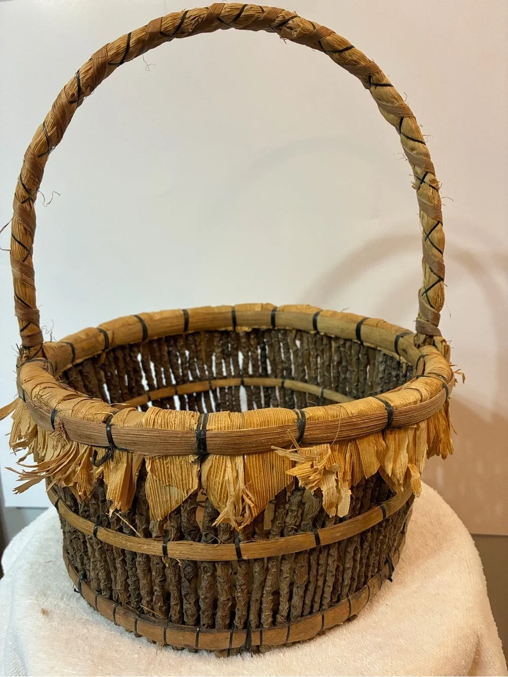 Handcrafted rustic corn husk and twig folk art basket